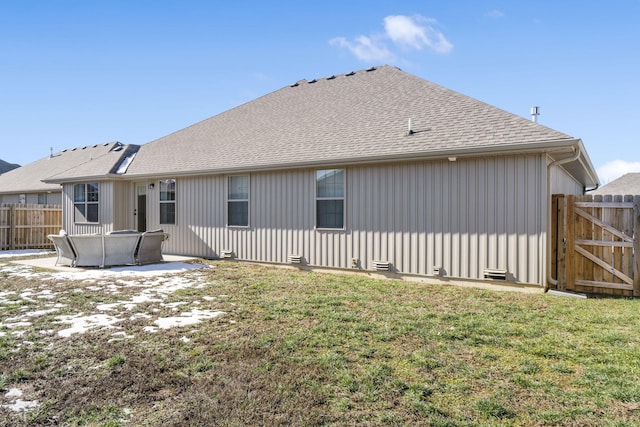 back of house featuring a lawn and a patio