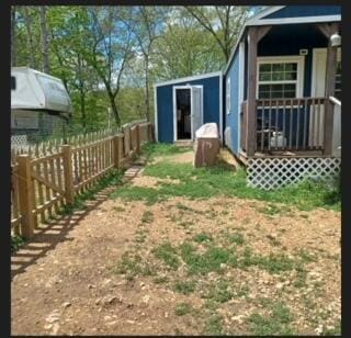 389 Osage Ln, Pineville, MO 64856 - view of yard featuring fence, an outbuilding, and a storage unit