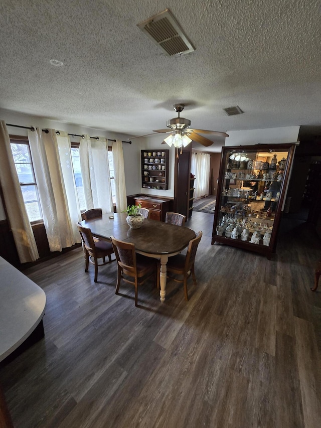 dining space featuring ceiling fan and dark wood-type flooring