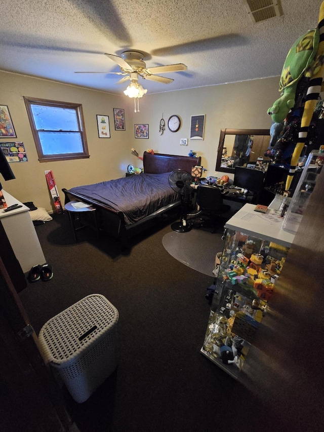 bedroom with a textured ceiling and ceiling fan