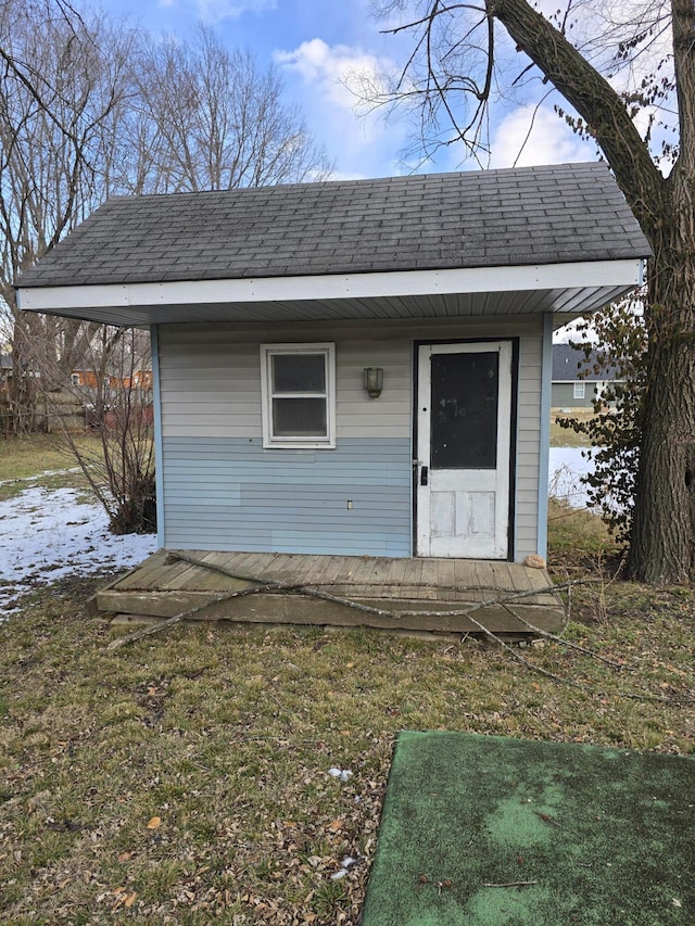 view of front facade with a front lawn and an outbuilding