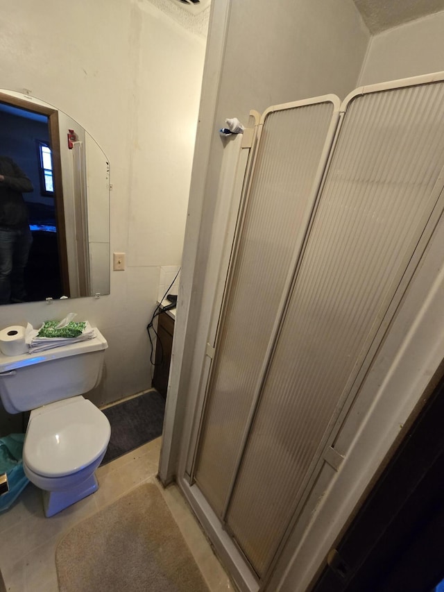 bathroom featuring tile patterned floors and toilet