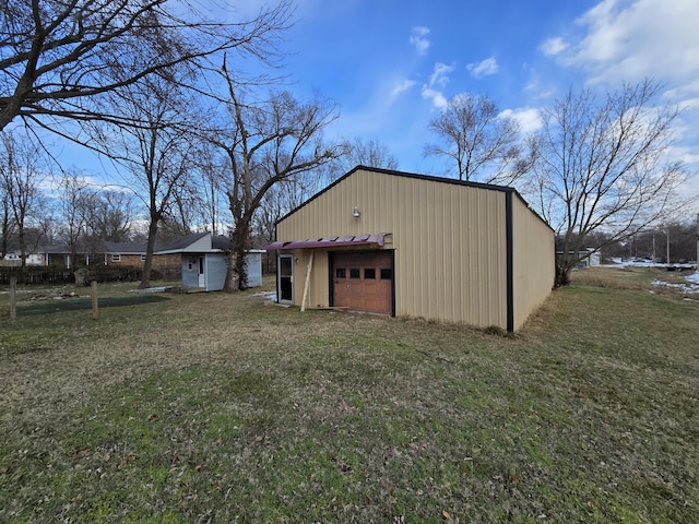 view of outdoor structure featuring a garage and a lawn