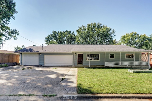 ranch-style home featuring a front lawn, a garage, and a porch