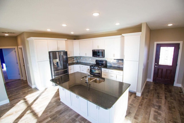 kitchen featuring appliances with stainless steel finishes, white cabinetry, and sink