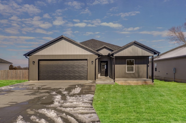 view of front of home featuring a garage and a front lawn