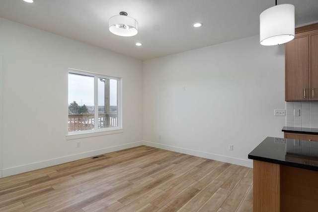 unfurnished dining area featuring light hardwood / wood-style flooring