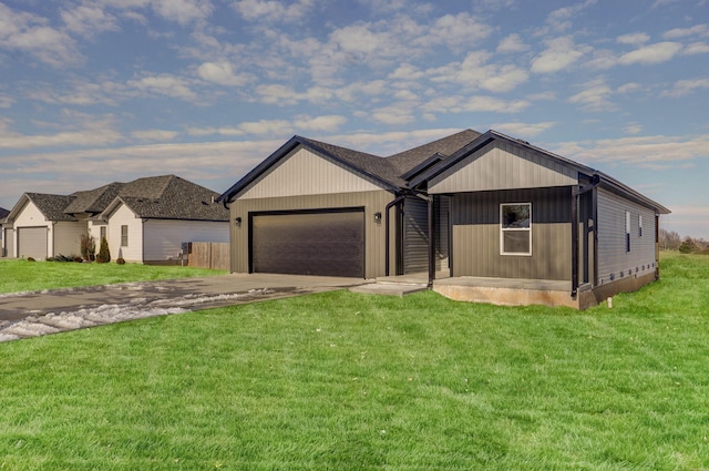 view of front of home with a front yard and a garage