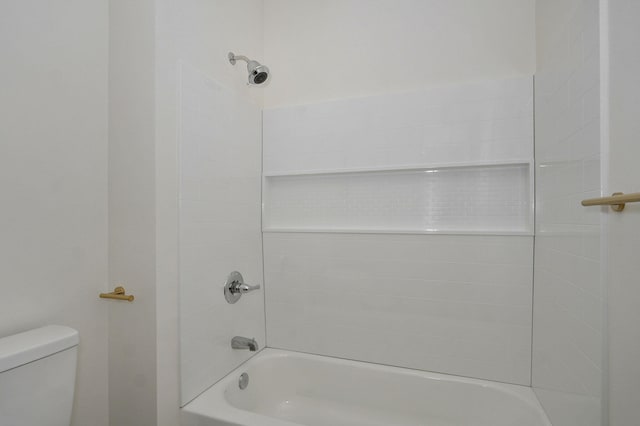 bathroom with shower / bathing tub combination and toilet