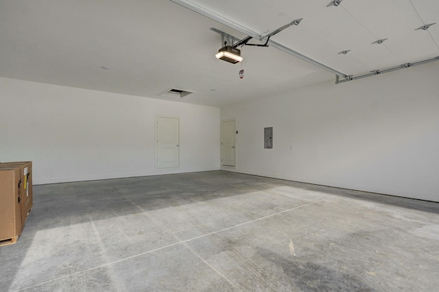 garage featuring electric panel and a garage door opener