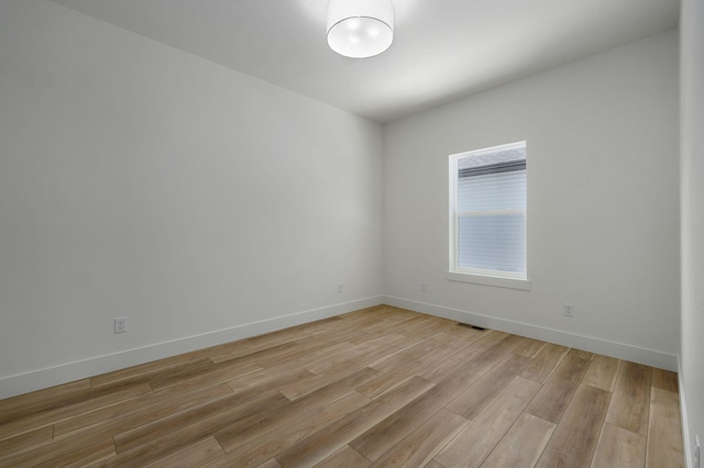 empty room with light hardwood / wood-style floors