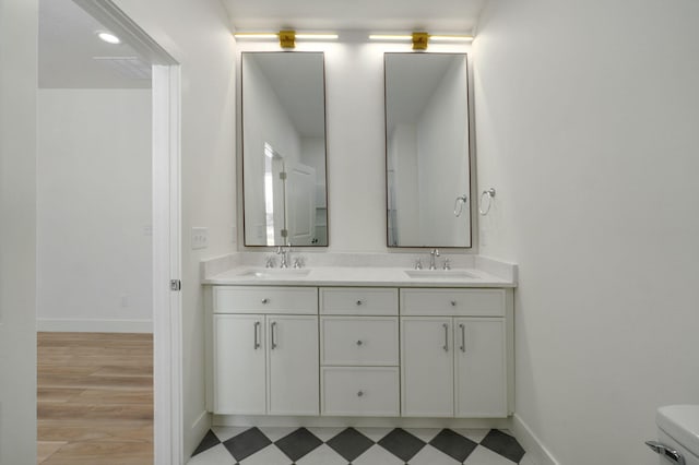 bathroom featuring toilet and vanity