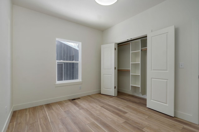 unfurnished bedroom featuring a closet and light hardwood / wood-style floors