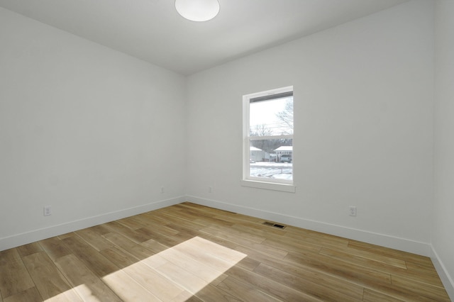 spare room featuring light hardwood / wood-style floors