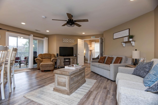 living room featuring ceiling fan and light wood-type flooring