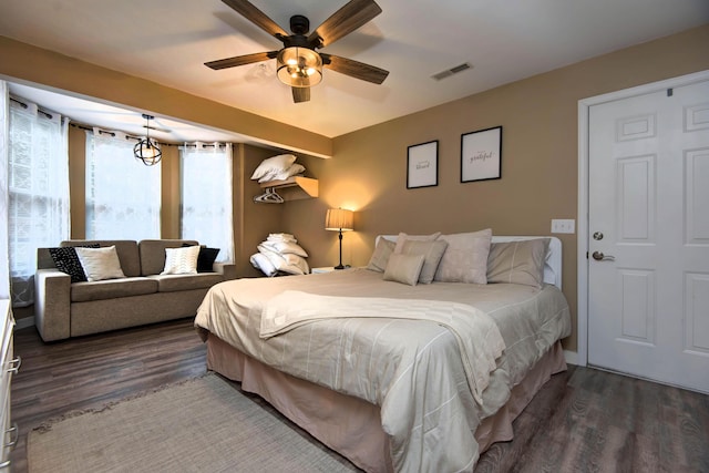 bedroom featuring ceiling fan and dark wood-type flooring