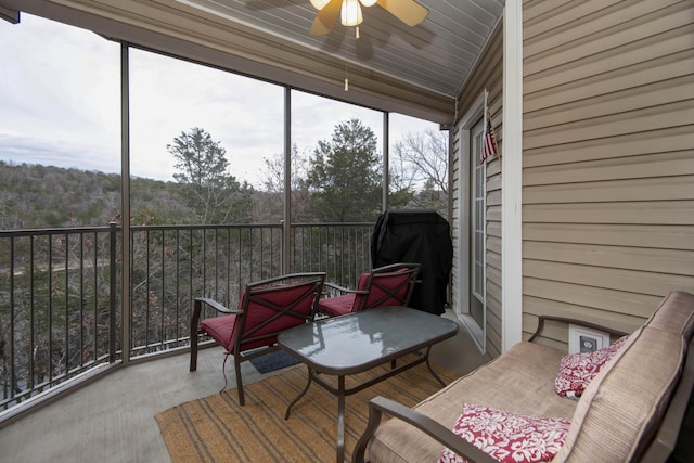 sunroom / solarium featuring ceiling fan