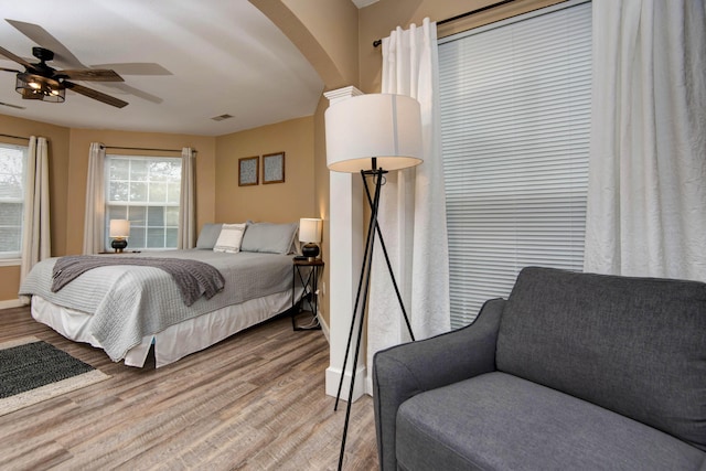 bedroom with ceiling fan and wood-type flooring