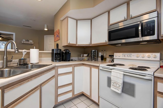 kitchen featuring sink, white cabinetry, and white electric stove