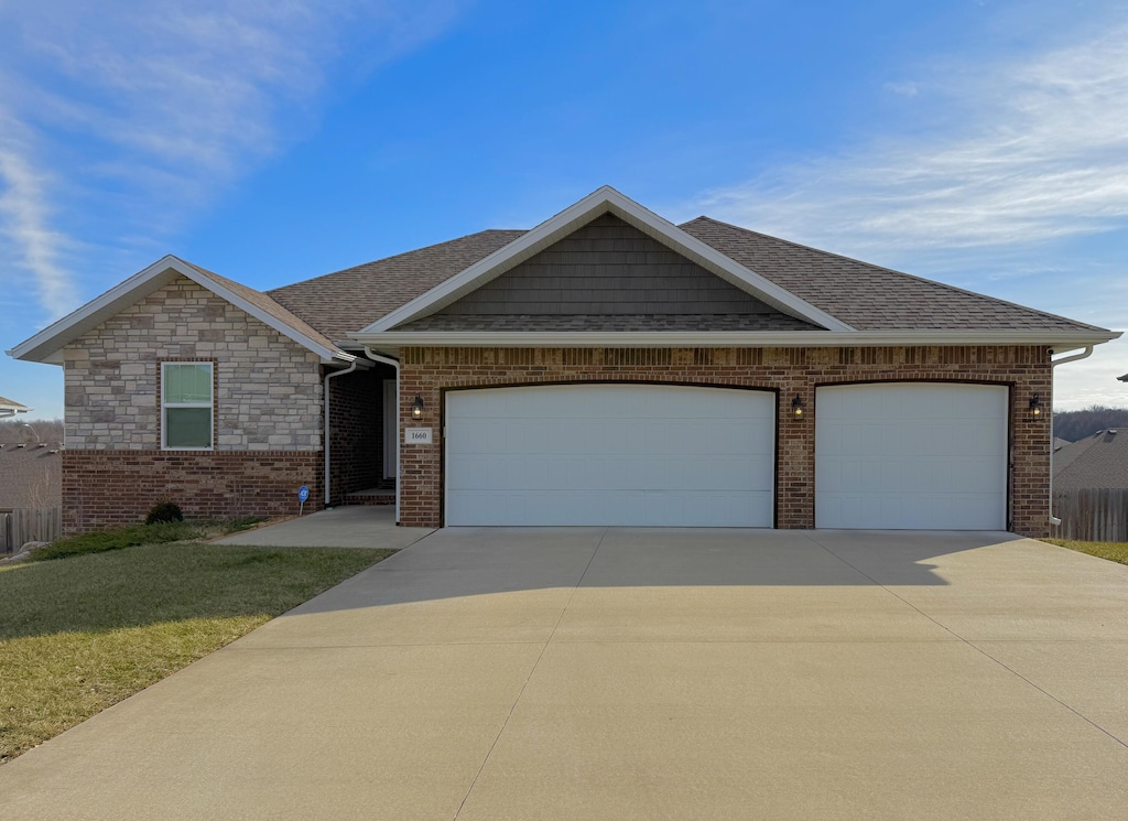 view of front of home featuring a garage and a front lawn