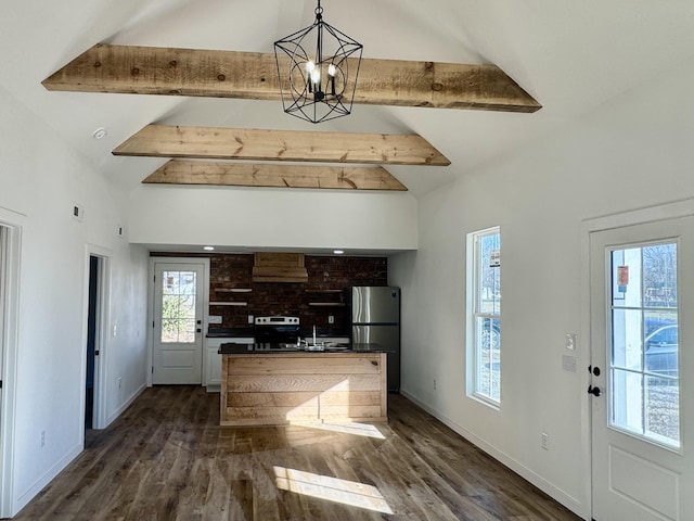 kitchen featuring custom exhaust hood, vaulted ceiling with beams, stainless steel fridge, and an inviting chandelier