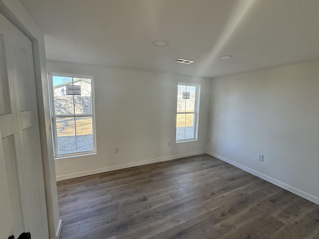 empty room with dark wood-type flooring