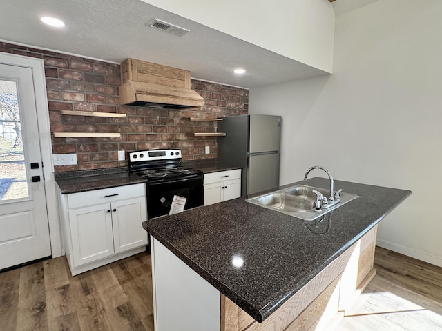 kitchen with premium range hood, a center island with sink, sink, black range with electric cooktop, and white cabinets