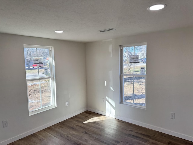 spare room featuring dark hardwood / wood-style flooring