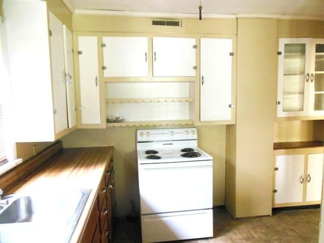 kitchen featuring electric stove, crown molding, white cabinets, and sink