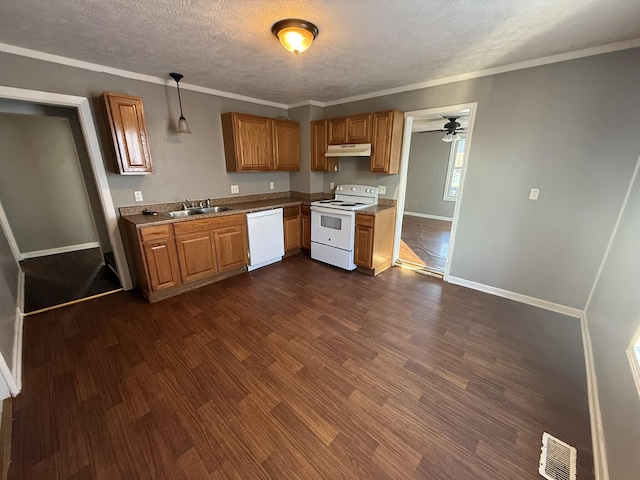 kitchen featuring white appliances, dark hardwood / wood-style flooring, a textured ceiling, pendant lighting, and sink