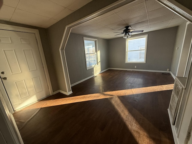 foyer with ceiling fan, a paneled ceiling, and dark hardwood / wood-style floors