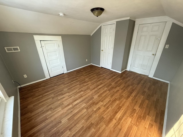 additional living space featuring vaulted ceiling and wood-type flooring