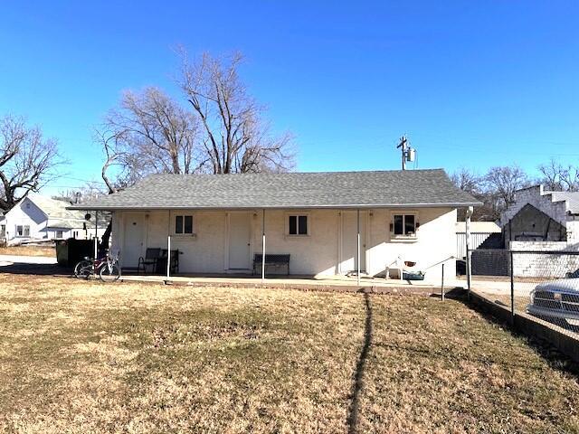 rear view of house with a patio area and a lawn