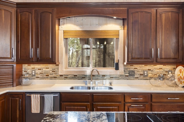 kitchen featuring light stone countertops, decorative backsplash, dishwasher, and sink