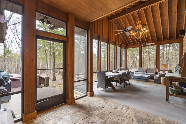 sunroom / solarium with lofted ceiling, ceiling fan with notable chandelier, and wooden ceiling