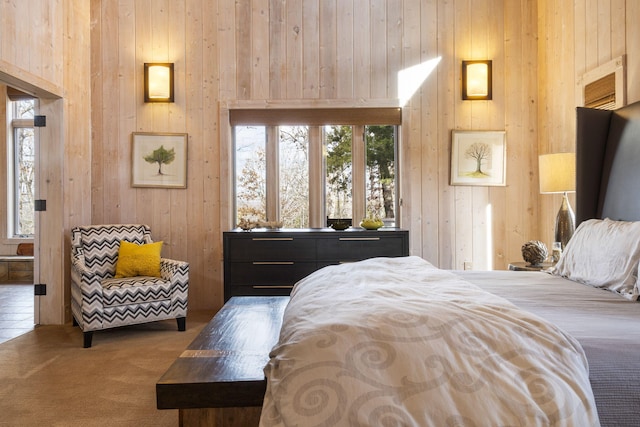 carpeted bedroom featuring wooden walls