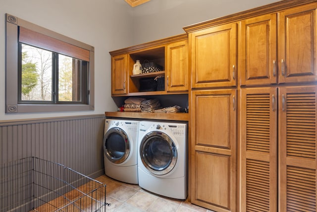 washroom with cabinets and washer and clothes dryer