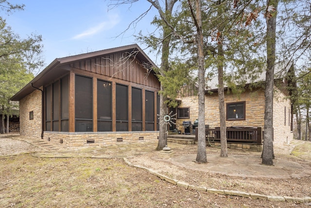 rear view of property featuring central air condition unit and a sunroom