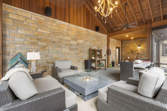 living room with wooden ceiling, beam ceiling, ceiling fan with notable chandelier, and high vaulted ceiling