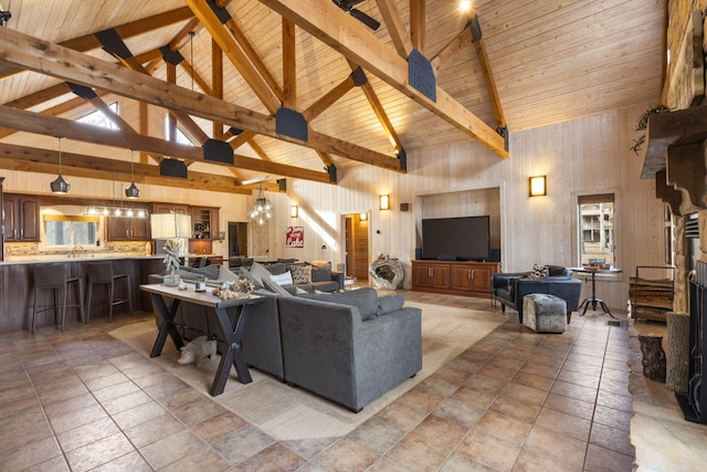 tiled living room with wooden ceiling, beamed ceiling, and high vaulted ceiling