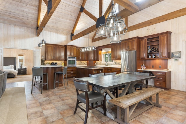 dining room with high vaulted ceiling, wooden ceiling, beam ceiling, and wooden walls