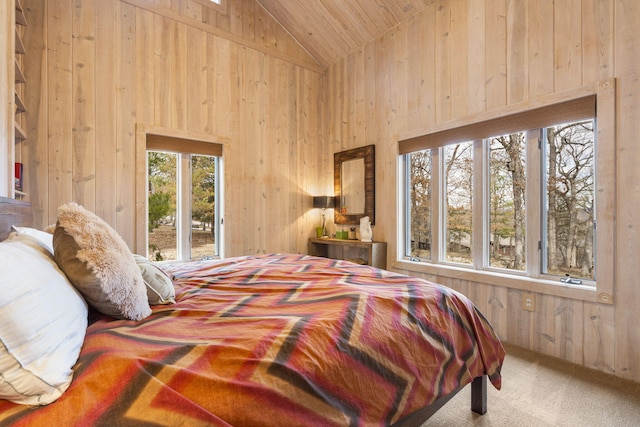 bedroom featuring lofted ceiling, wood ceiling, wood walls, access to outside, and carpet flooring