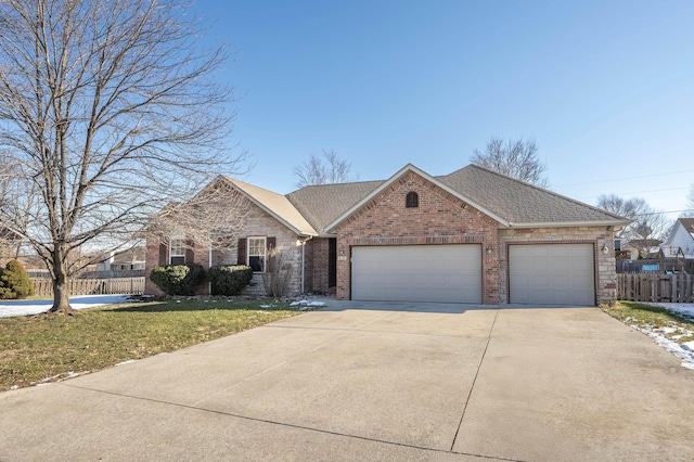 ranch-style house featuring a garage and a front lawn