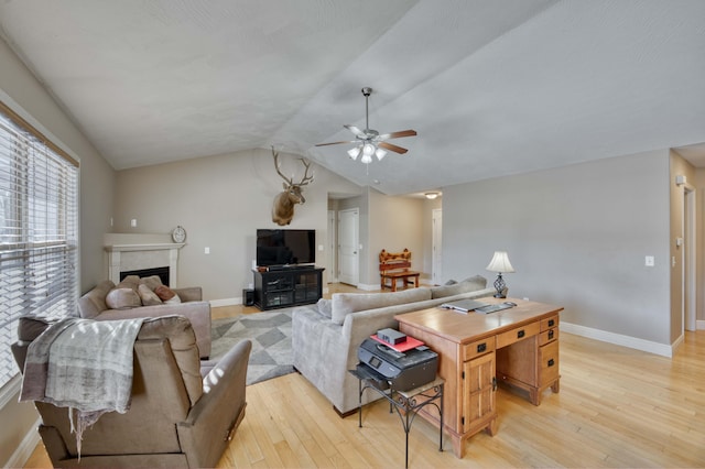 living room featuring lofted ceiling, ceiling fan, a fireplace, and light hardwood / wood-style floors