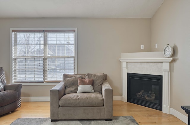 living area with light wood-type flooring and a fireplace