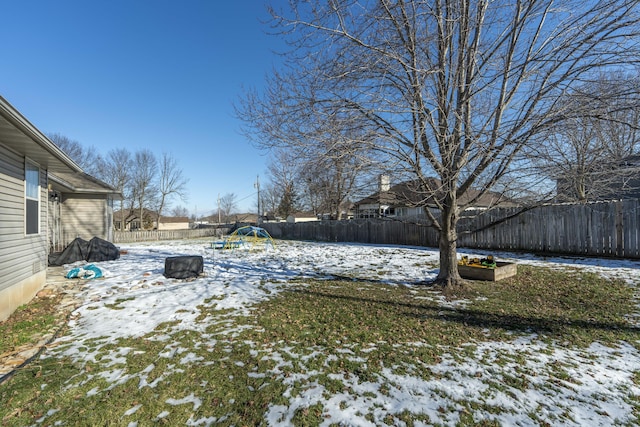 snowy yard with a trampoline