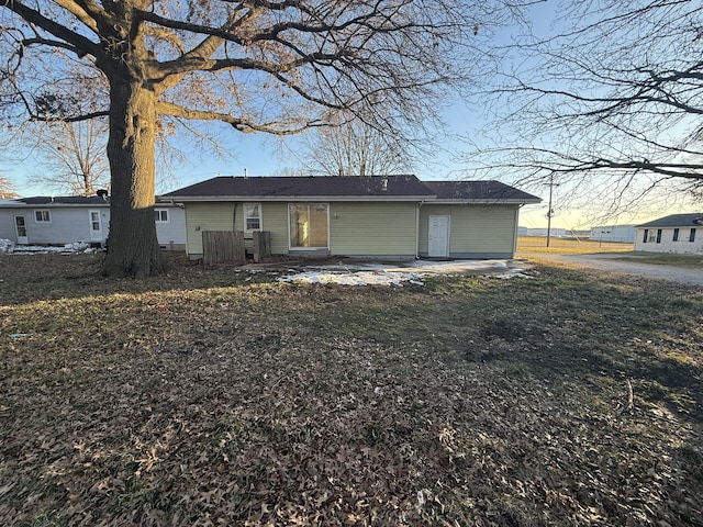 view of back house at dusk