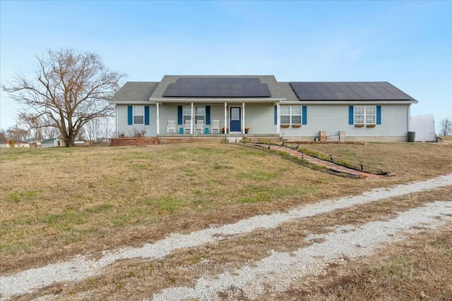 ranch-style house with solar panels, a front lawn, and a porch