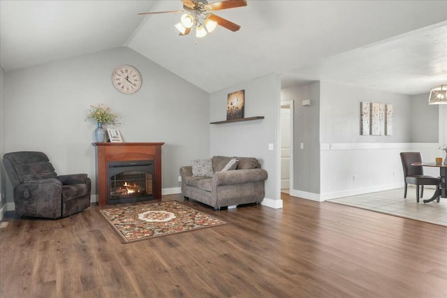 living area with hardwood / wood-style flooring, lofted ceiling, and ceiling fan