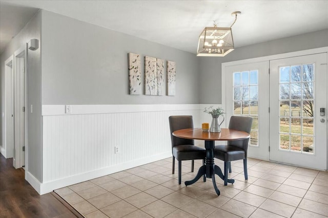 dining area with light tile patterned floors and a chandelier